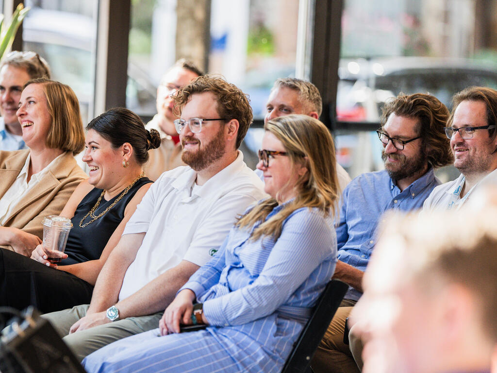 A group of people sitting at Stand Together HQ