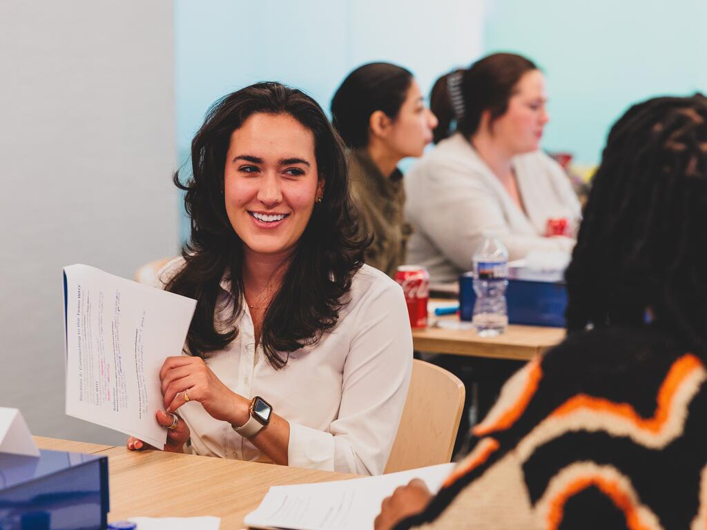 people talking at a desk