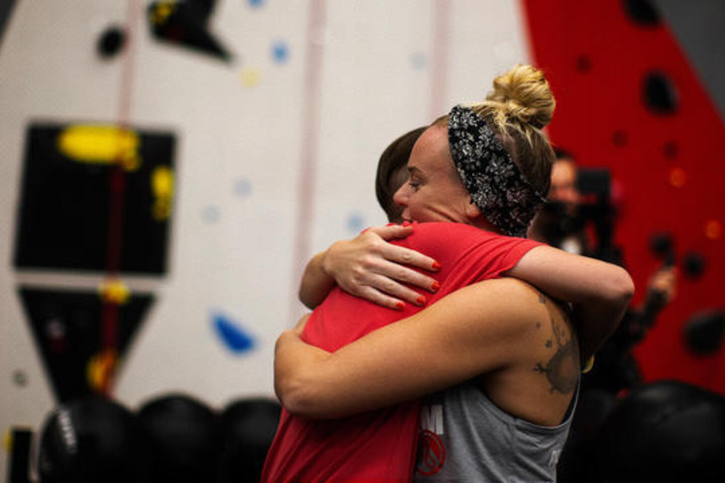 Two participants of The Phoenix, a national sober active community, hug during a training session.