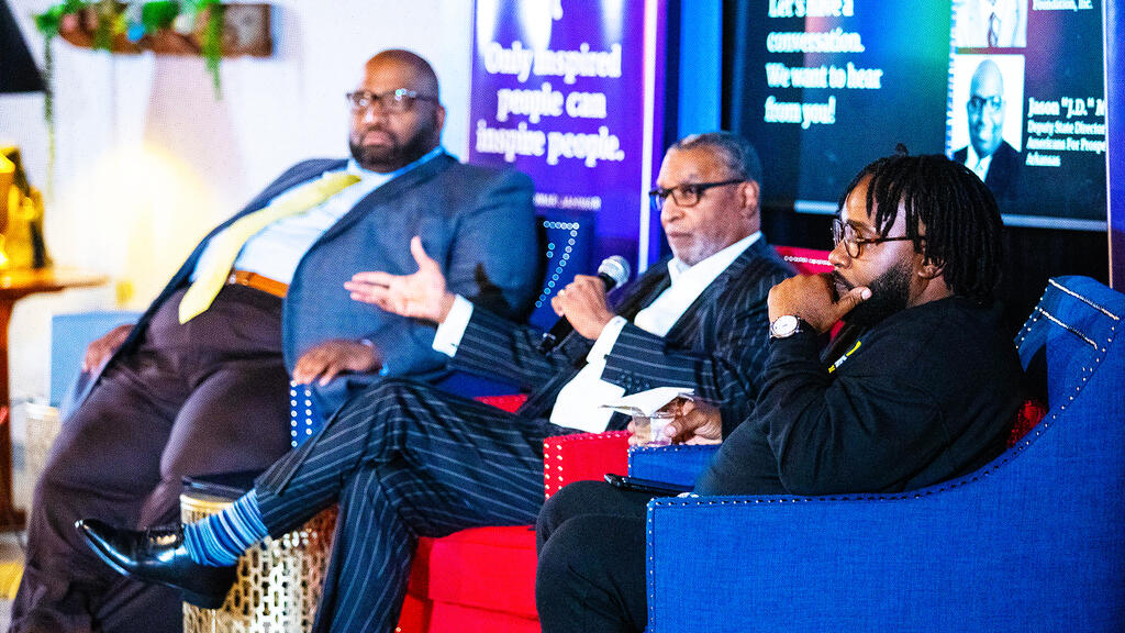 three men on a stage