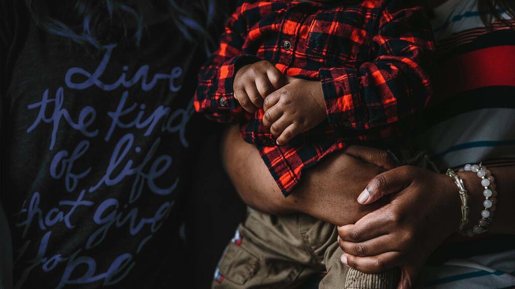 woman embracing child