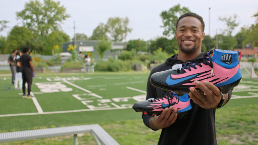 Derrick Barnes holding custom my cause my cleats