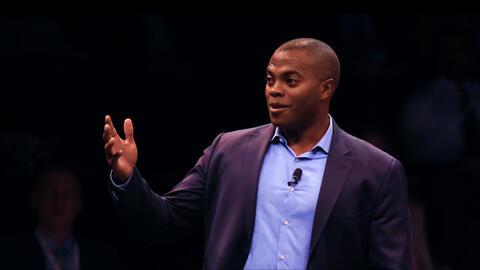 Man in suit gesturing on stage