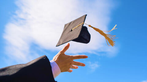 Graduate throwing their cap in the air.