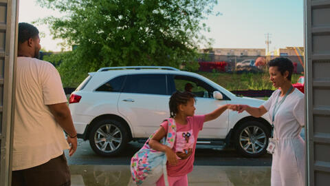Child getting dropped off for school.