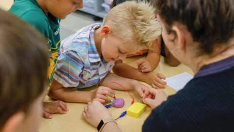 Students working on an activity with an instructor.