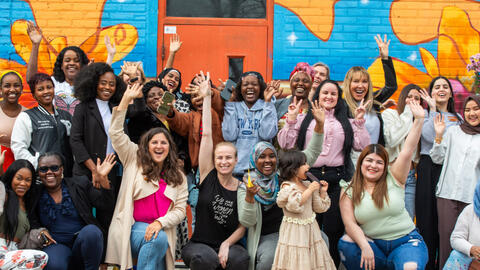 Group of women smiling for a photo.