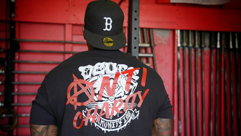 Black tee with red writing and a white shape