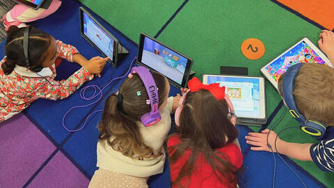 Students using Boddle on tablets in classroom.