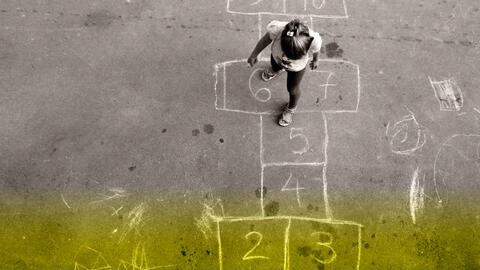 Girl playing Hopscotch.