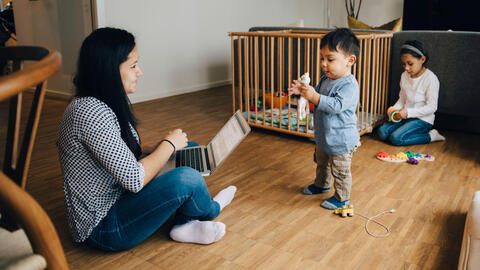Mother playing with her children.