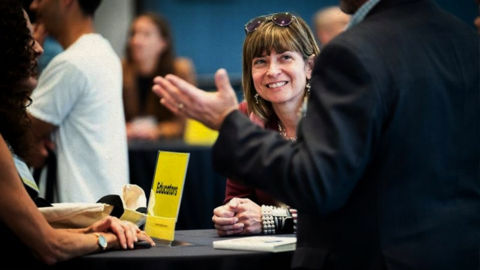People conversing at an event.