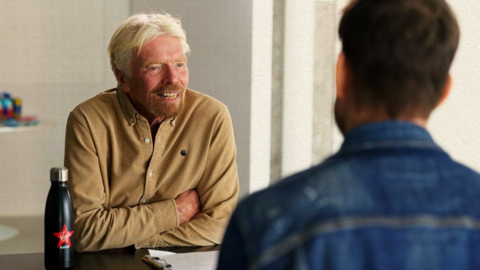 Two men speaking to each other.
