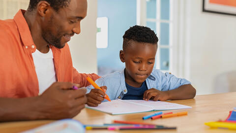 Parent working on homework with their child.