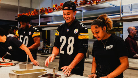 NFL Players Working in a Kitchen