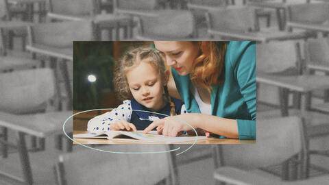 Student reading a textbook with a parent.