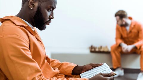 An incarcerated man reading a book