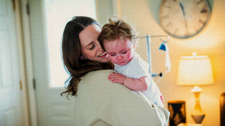 A mother holding her child.