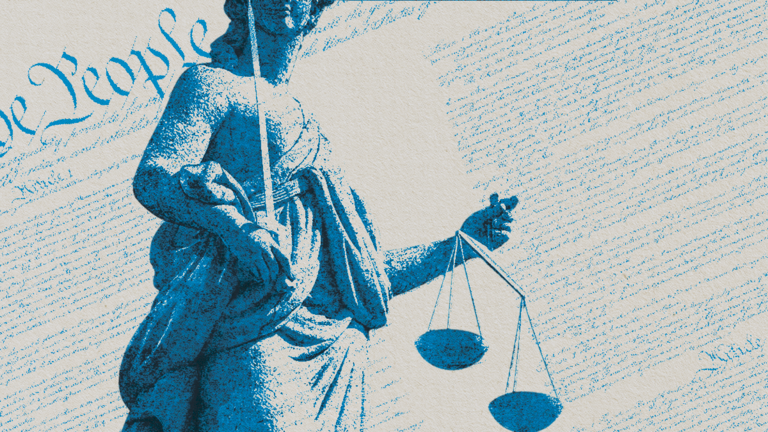 Statue of Lady Justice holding scales in front of the U.S. Constitution with "We the People" visible.