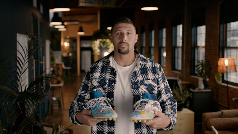 Austin Hooper holding his cleats.