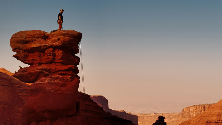 Man standing on top of a mountain.