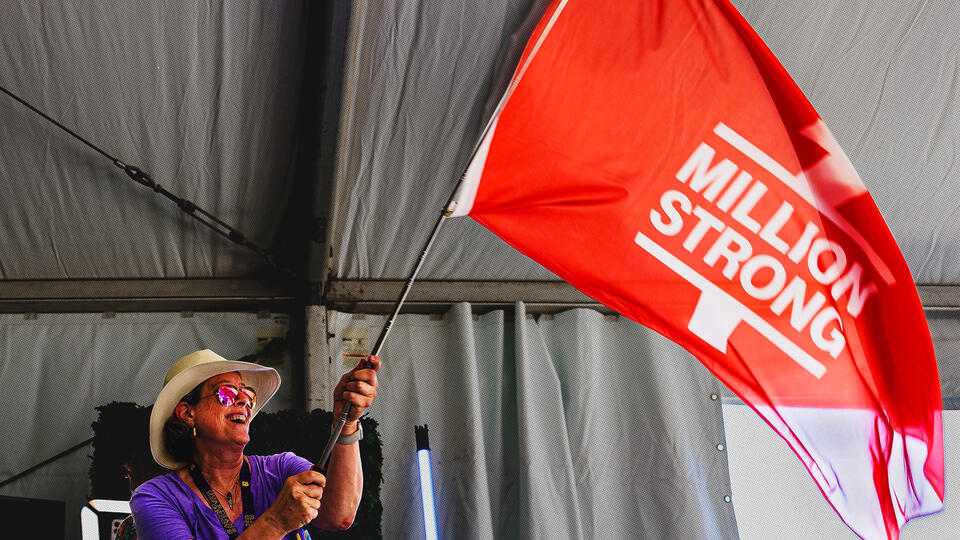 Woman waving a 1 Million Strong flag