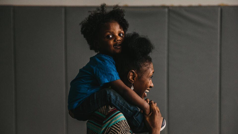 Toddler on mom's shoulders
