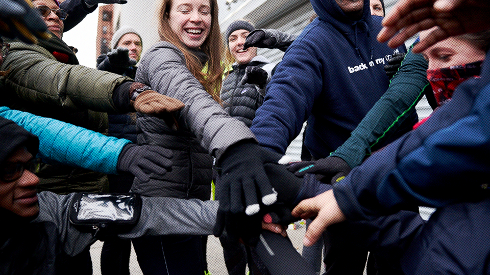 Group of people with all hands in the center