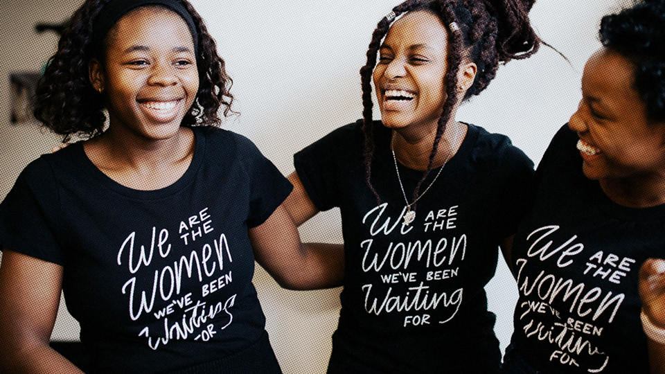 Three young women arm-in-arm