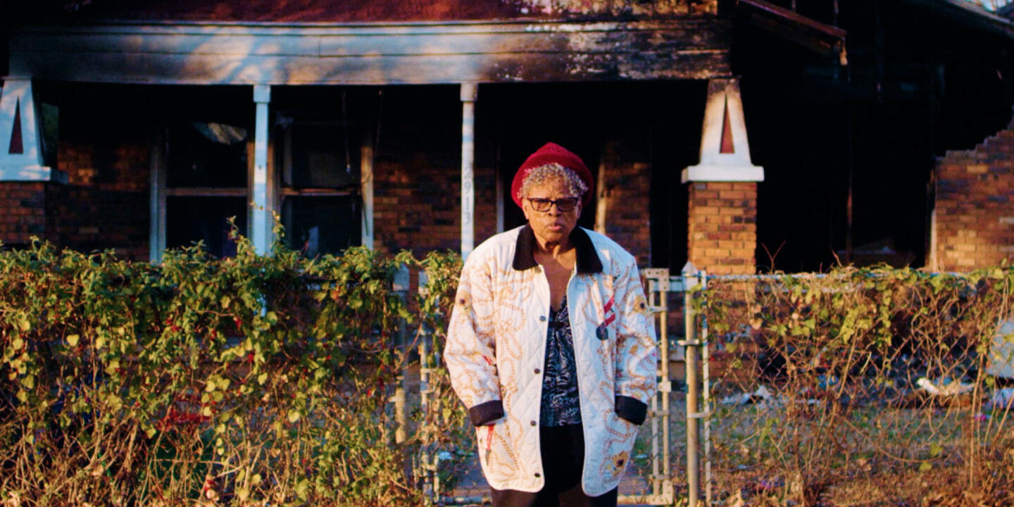 Opal Lee stands outside of her home after it burned