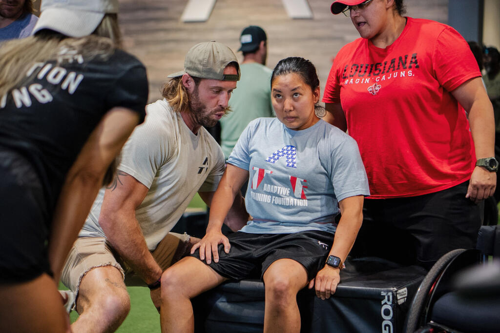 ATF founder David Vobora helps a participant with a workout.