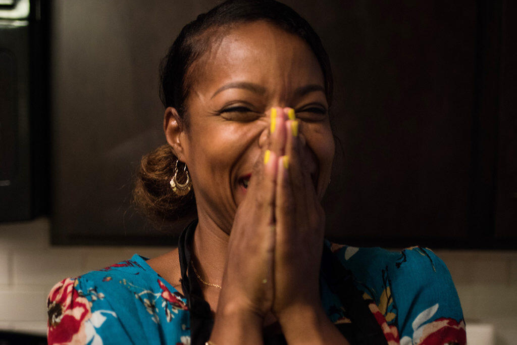 Homestretch graduate, Brandy, clasps her hands in joy