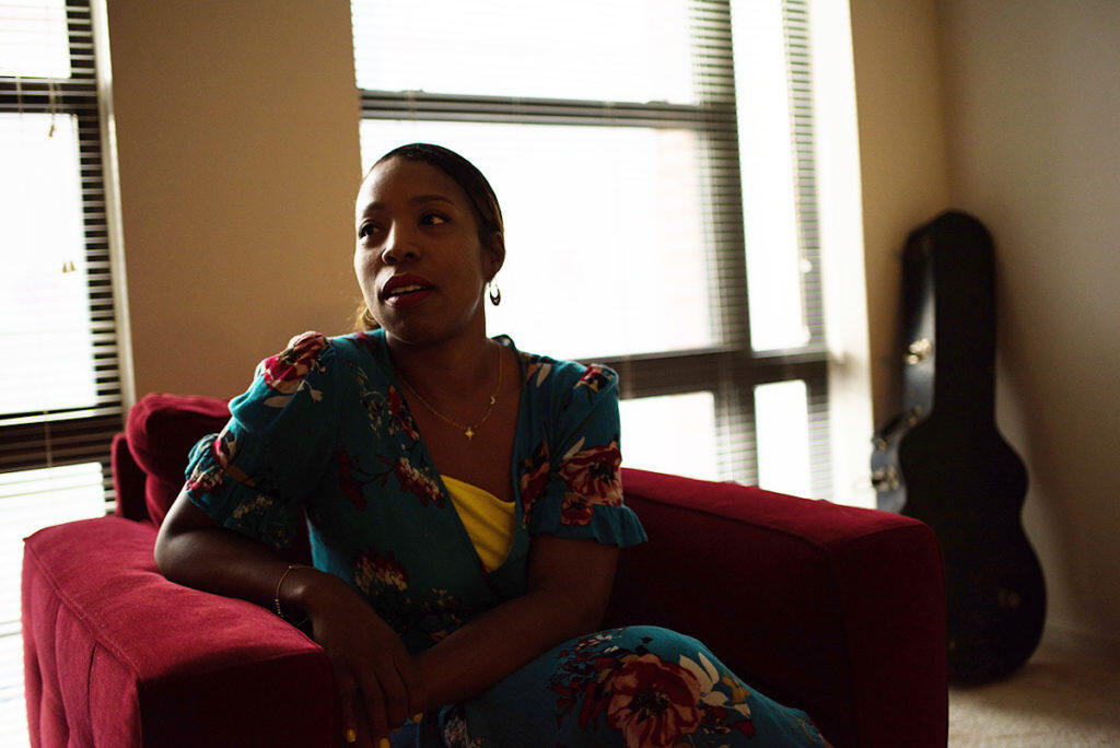 Brandy sits in an armchair