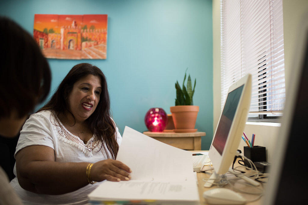 A teacher helps a student with school work