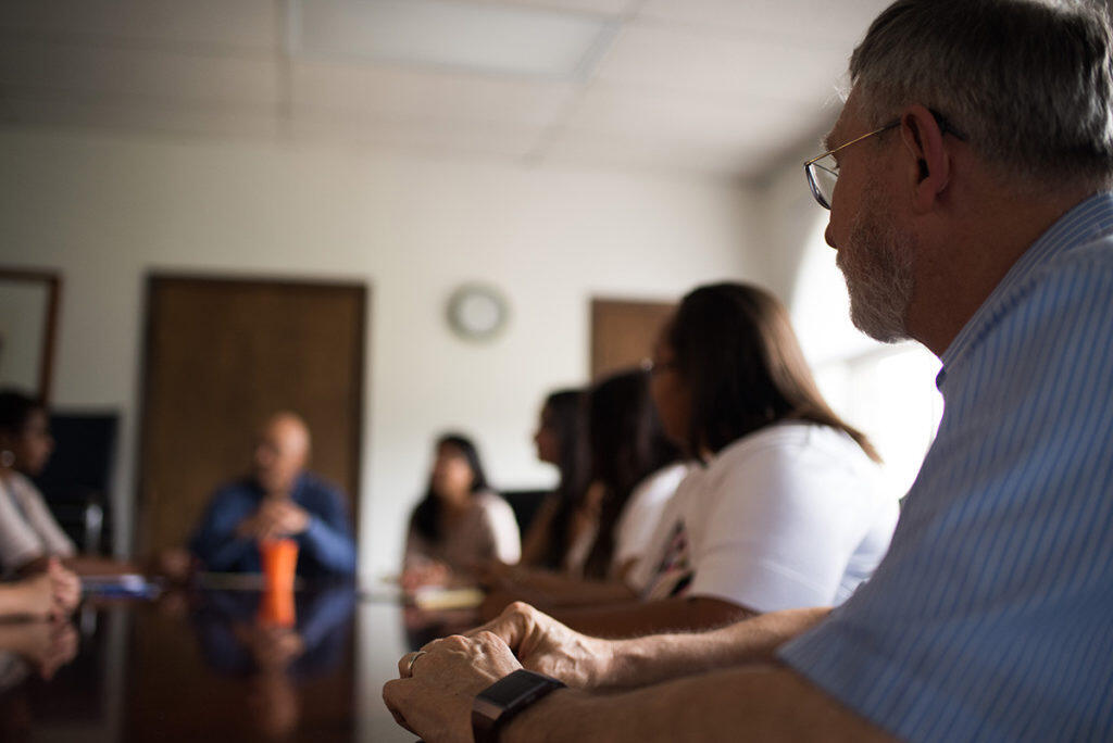 A group of people in a meeting