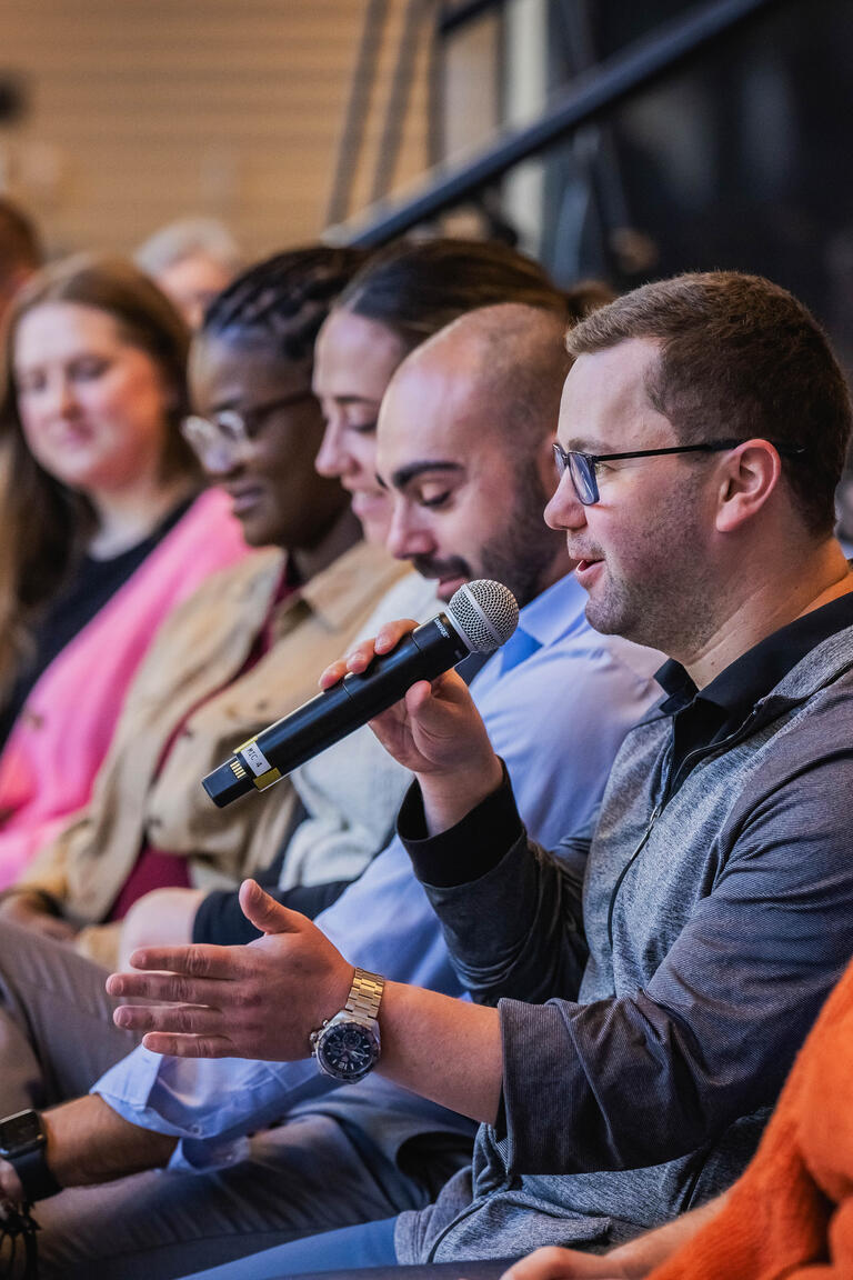 Man with a microphone at Stand Together HQ