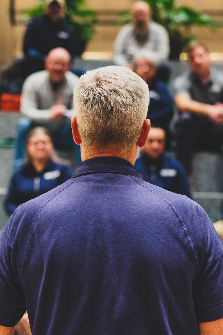 Man facing a crowd at Stand Together HQ
